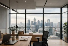 Modern office skyline view through large glass windows.