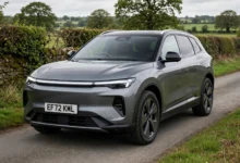 Facelifted Tesla Model Y electric SUV with full-width front light bar on a UK road